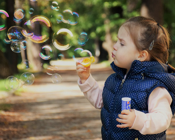 girl-playing-with-bubbles